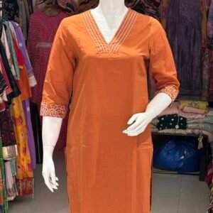 orange kurti with intricate white embroidery set.