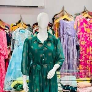 green printed midi dress with a collared neckline and a tie-up belt