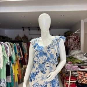 light-colored maxi dress with blue floral patterns and ruffled sleeves