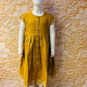 WONDER WILLOW A mustard-yellow girl's dress with white embroidery